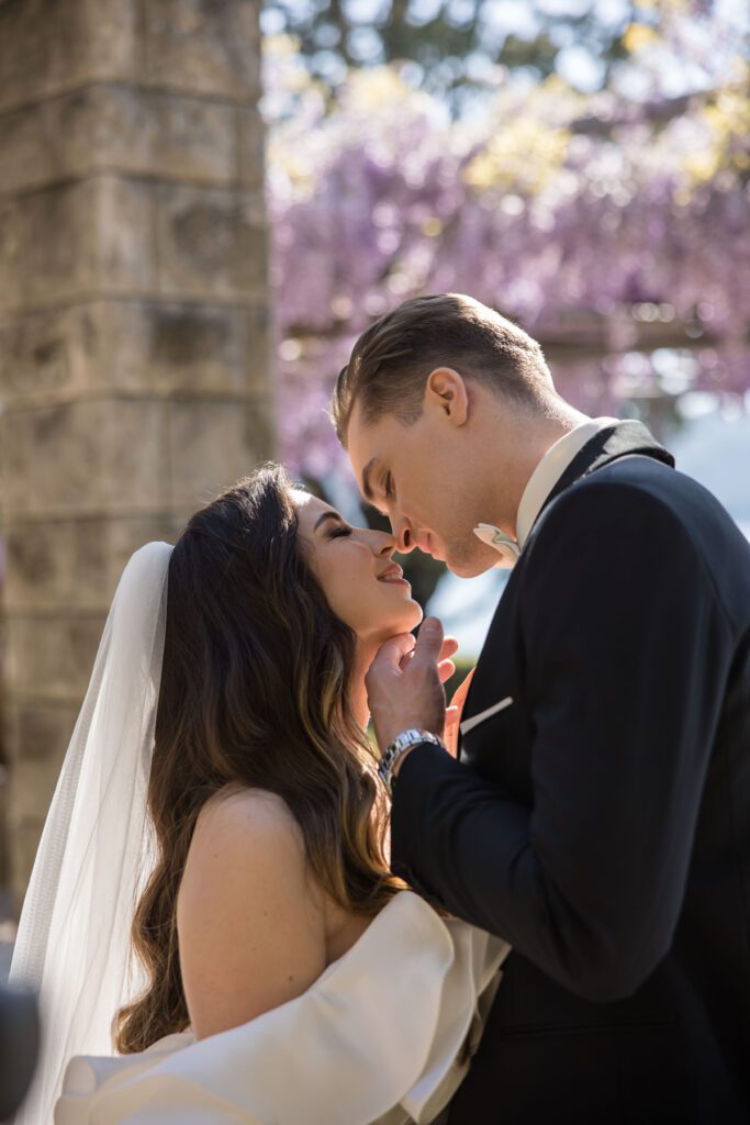 wedding couple close up portrait under wisteria in Italy
