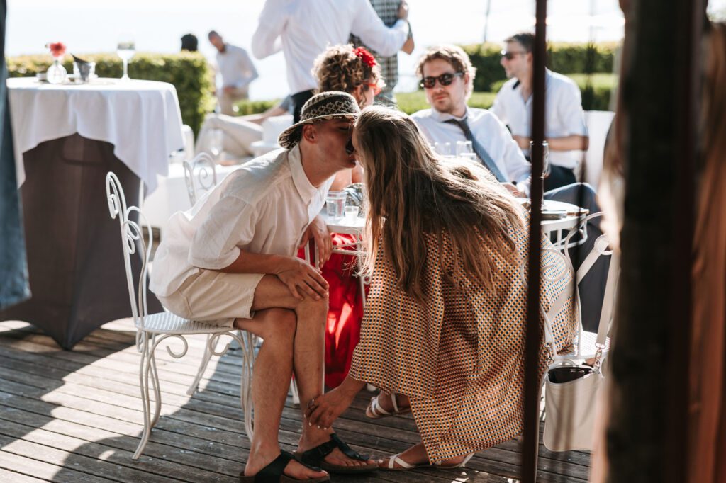 wedding guests kissing moment villa bonomo trieste italy candid reception