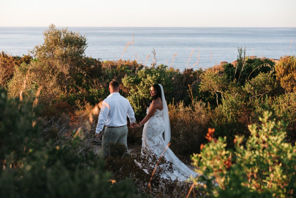 wedding couple walking through nature in Cefalù Sicily with sea view