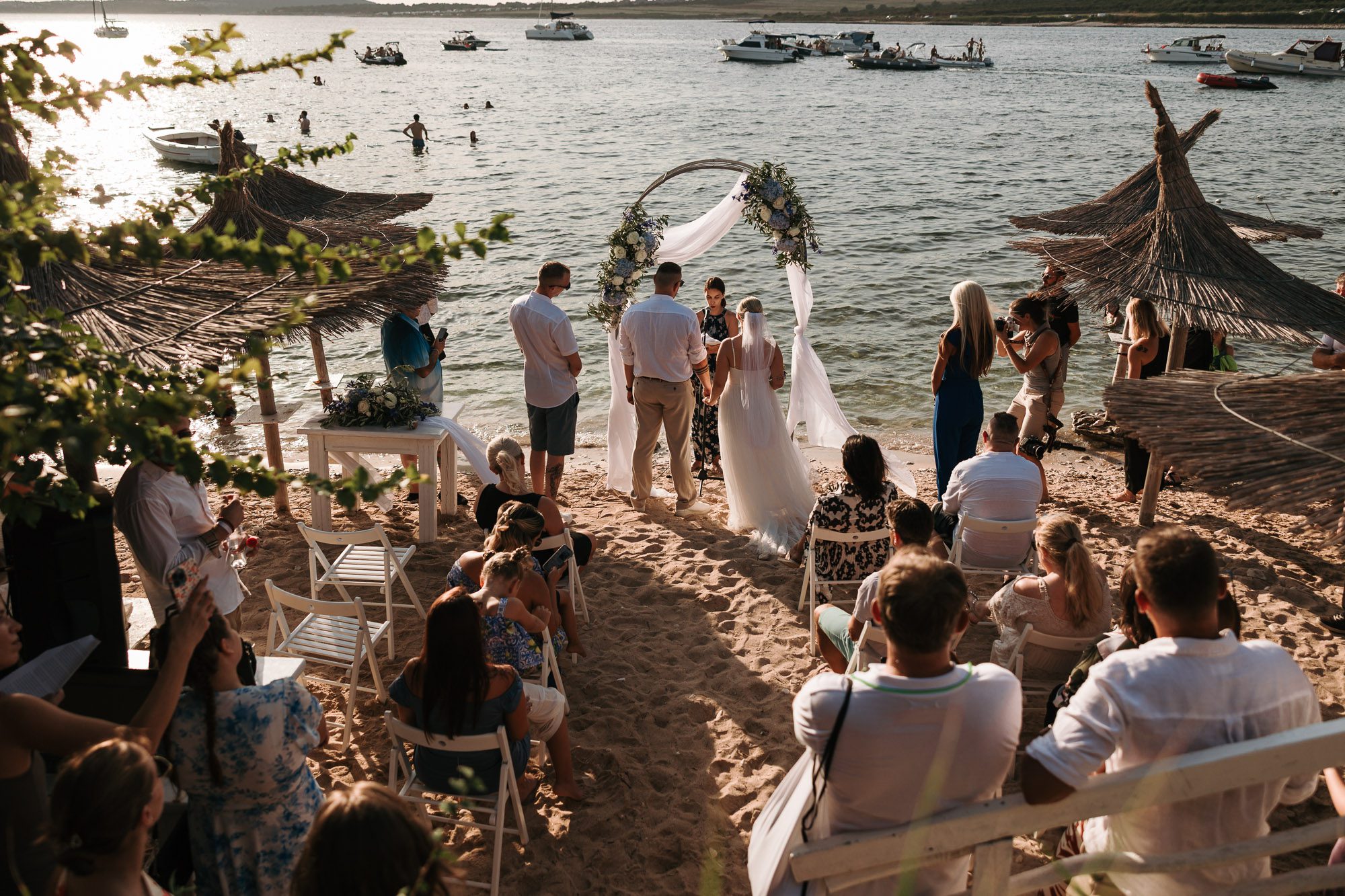 intimate beach wedding ceremony on Levan island Croatia with ocean view and guests at sunset