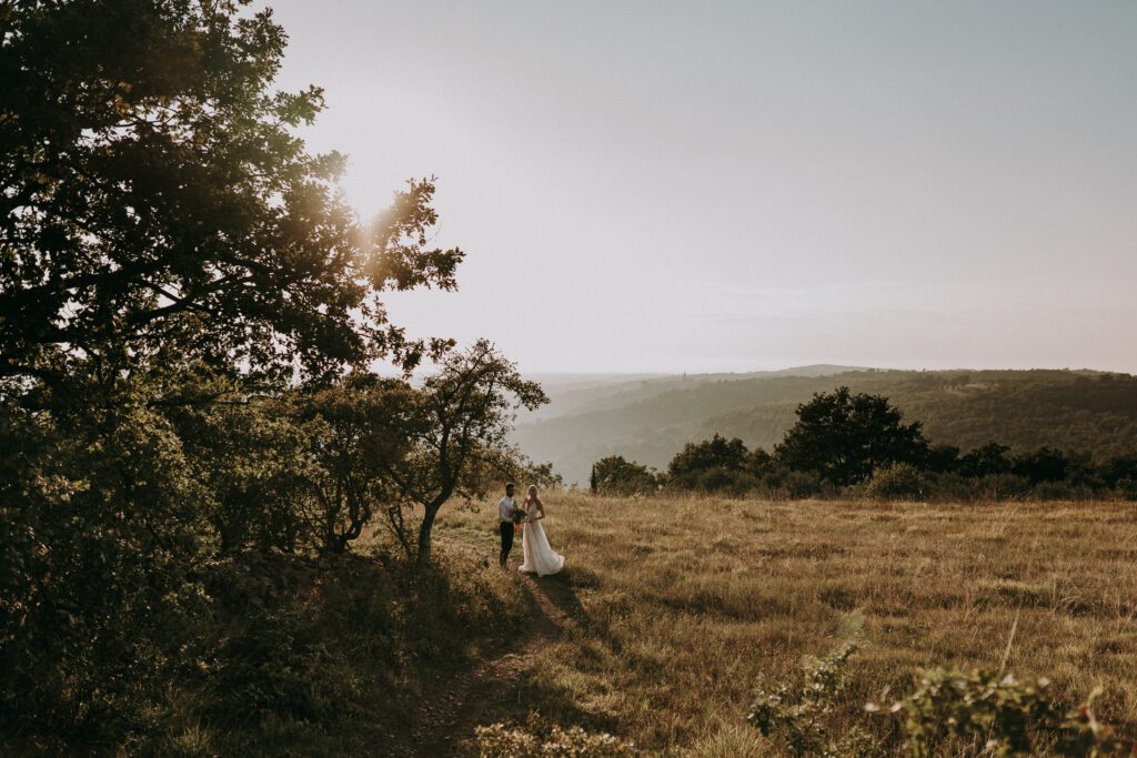 couple walking in sunset field near Grožnjan Istria Croatia elopement wedding location