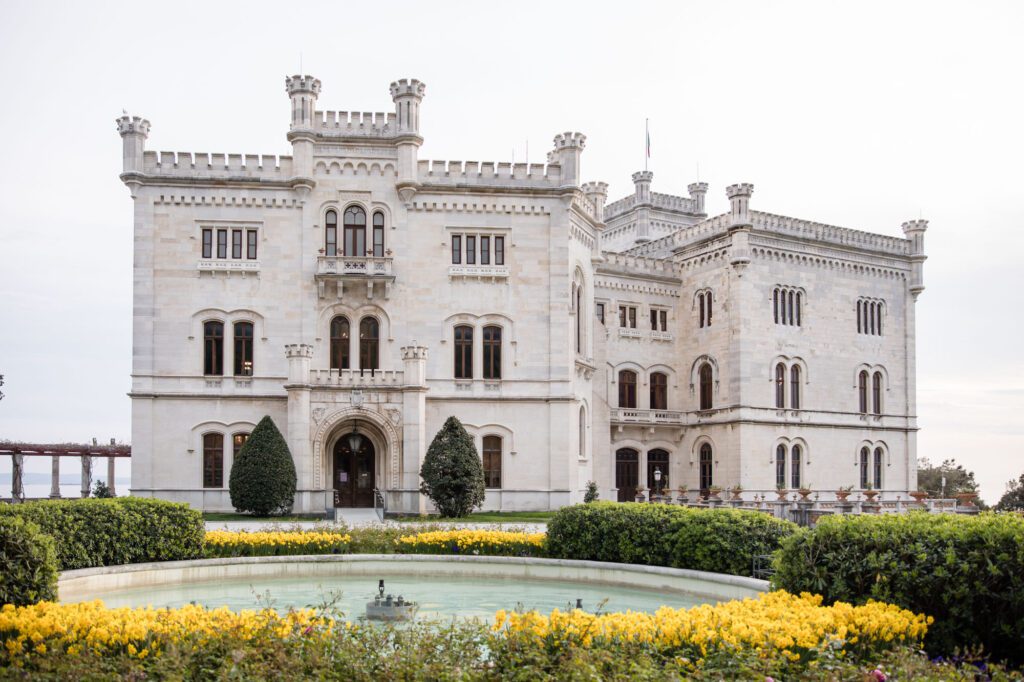 Miramare Castle Trieste Italy wedding venue with fountain and yellow flowers in garden