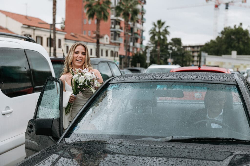 Bride smiling beside a vintage Mercedes in Koper, Slovenia, before continuing to her intimate wedding celebration.