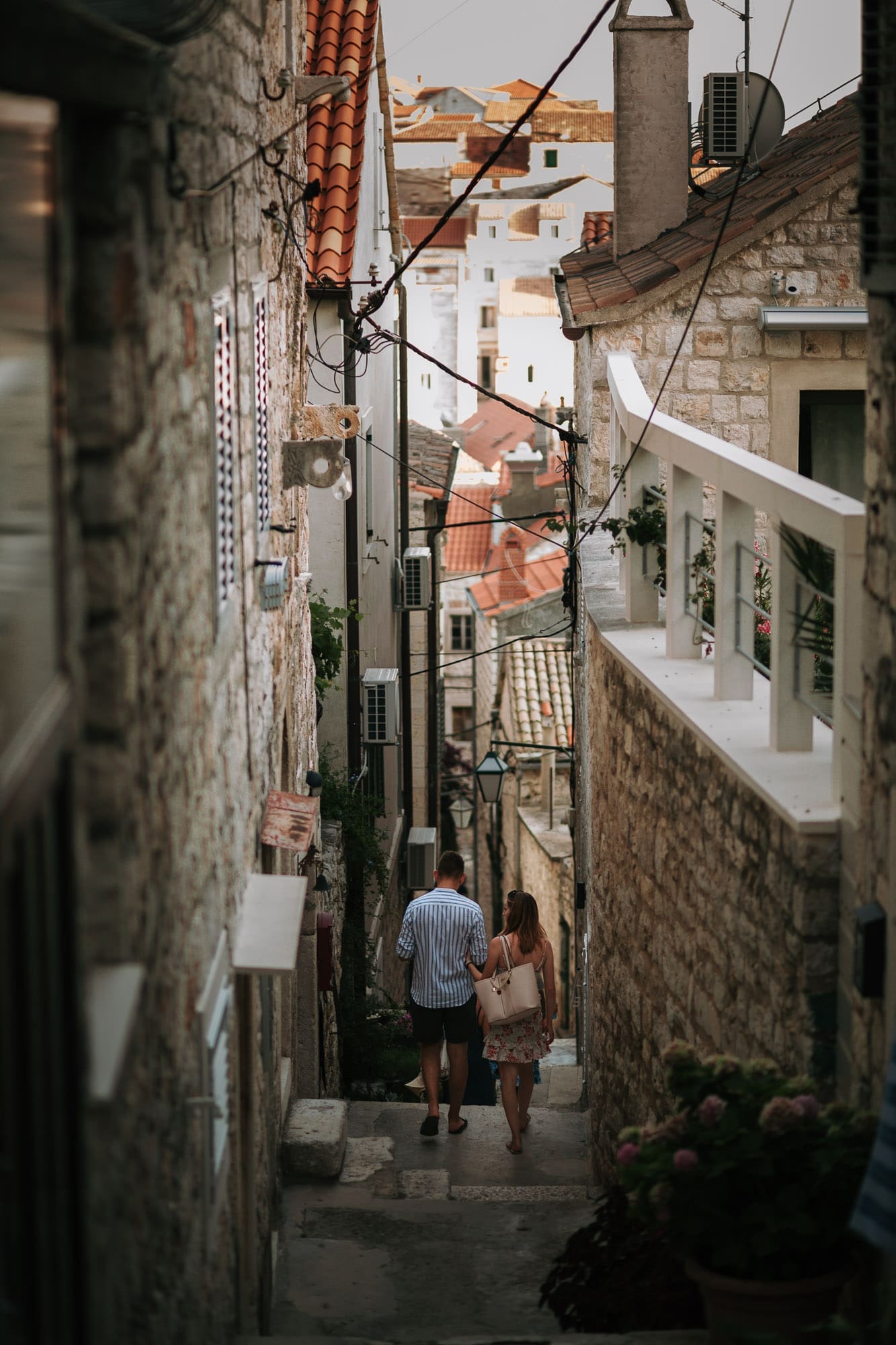 Couple walking through the narrow stone streets of Hvar town during an intimate Croatia elopement