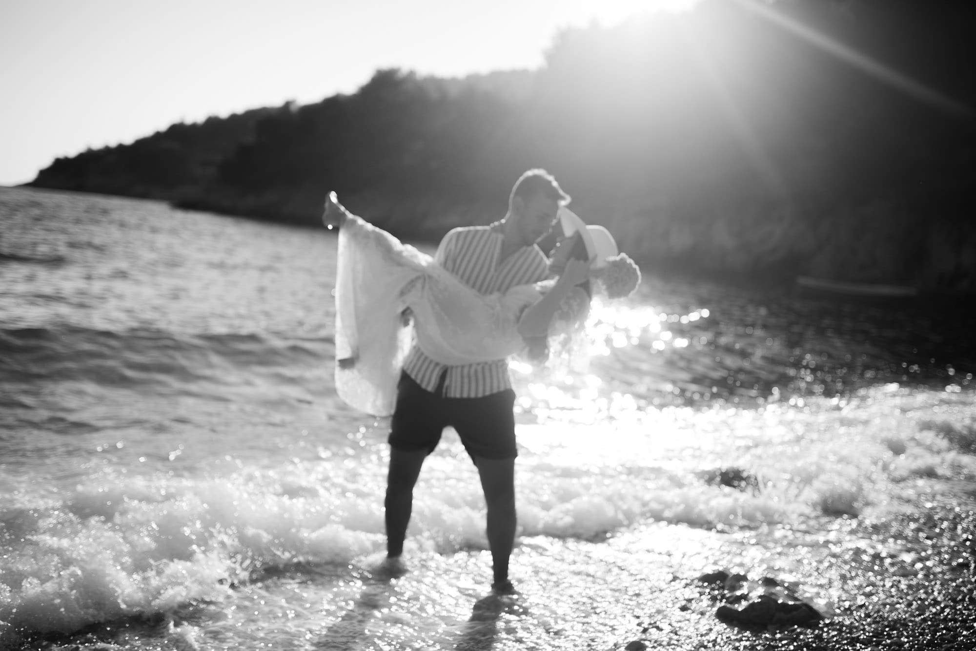 Bride and groom celebrating a romantic Hvar elopement in a hidden bay along the Croatian coast at sunset