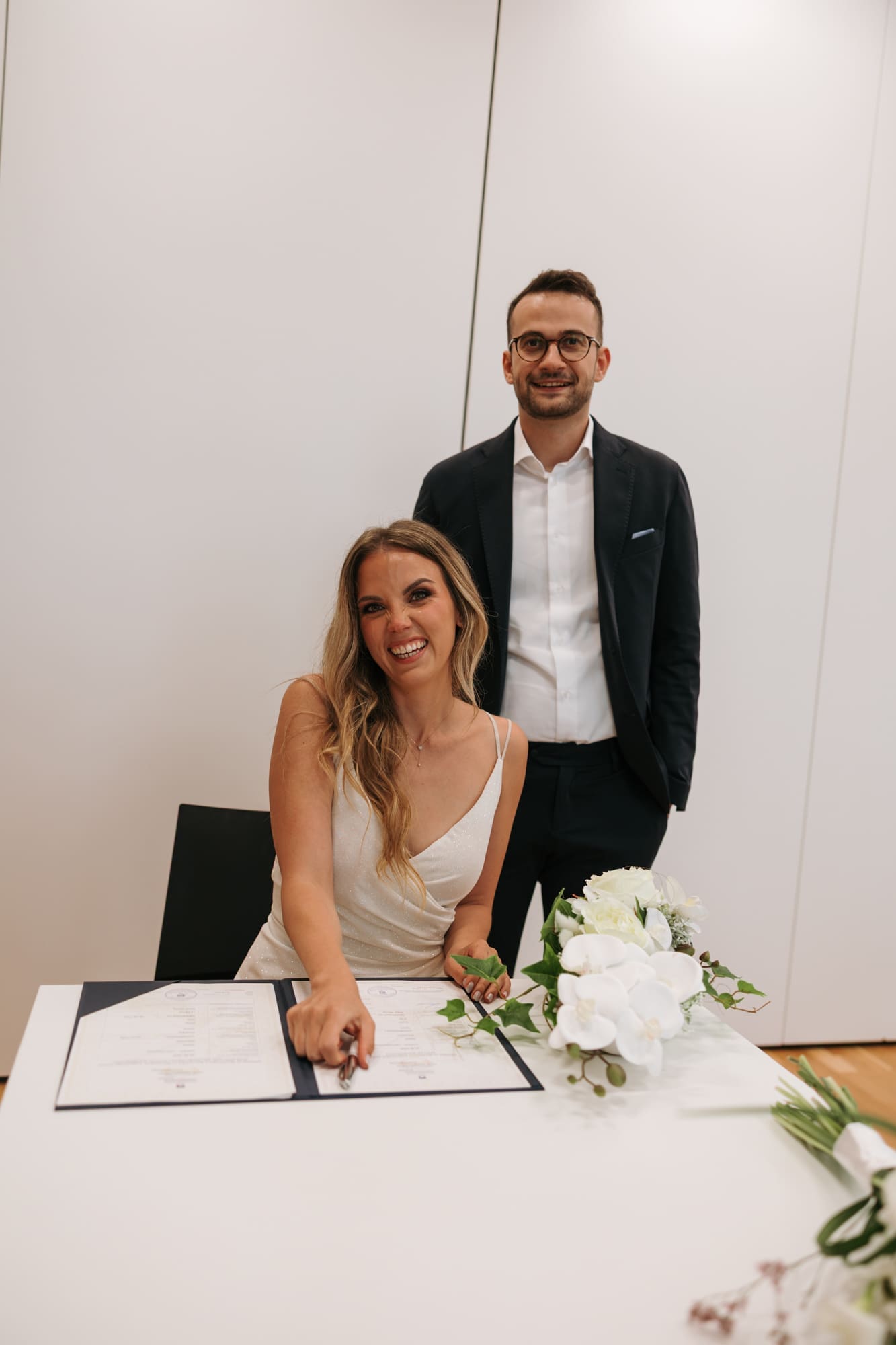 Bride signing the marriage register during a civil wedding ceremony in Koper, Slovenia.