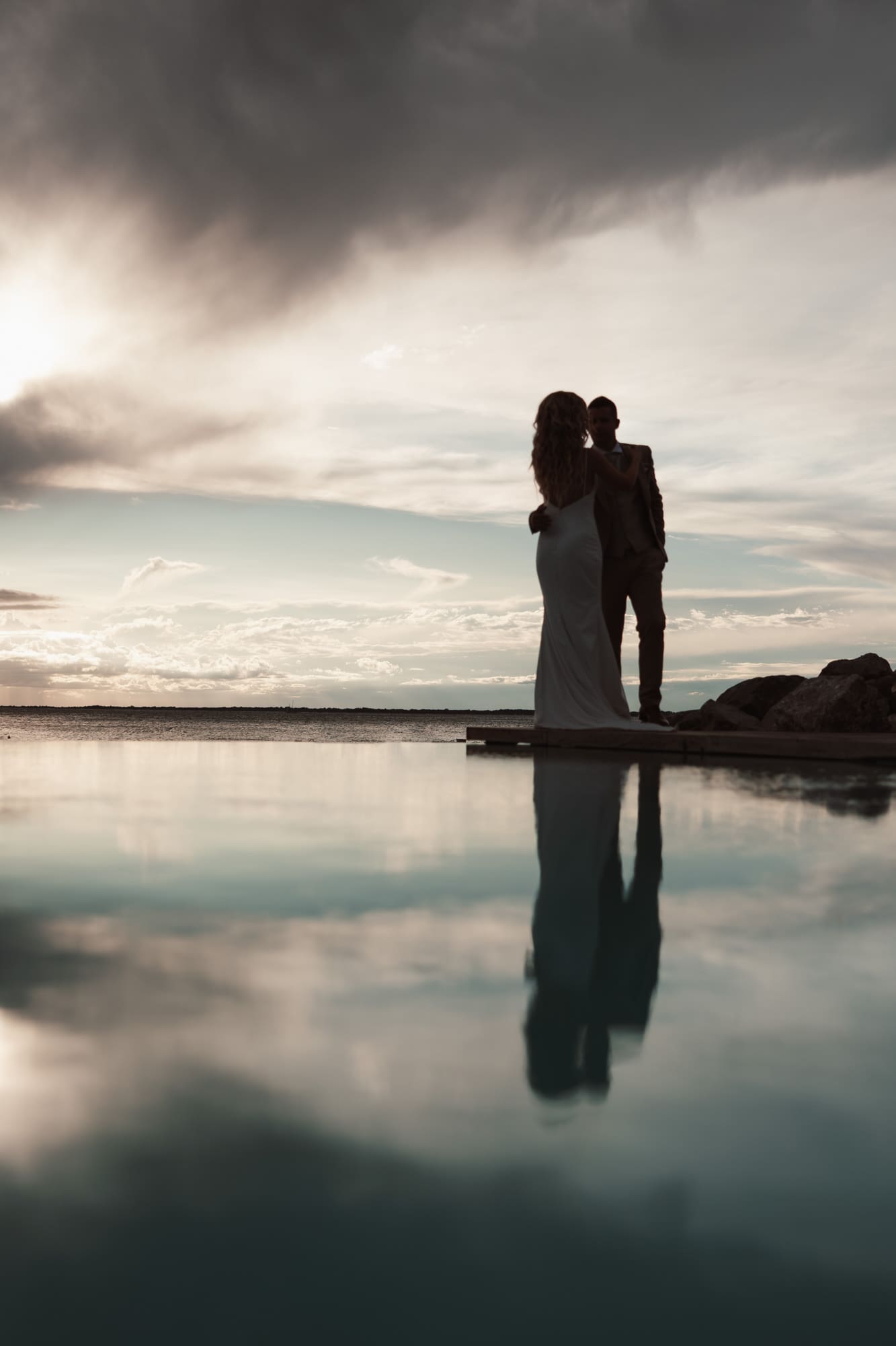 Silhouette portrait of Zala and Matej during wedding portraits in Portopiccolo under dramatic Adriatic skies.