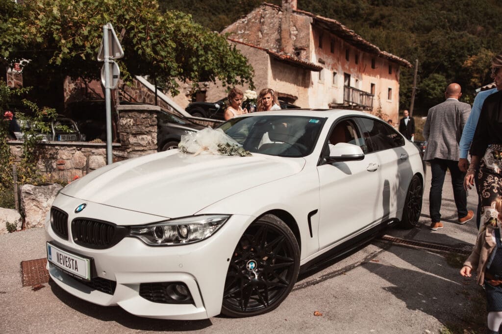 Wedding car arriving outside the Church of St. Michael in Šmihelj during Zala and Matej's wedding day.
