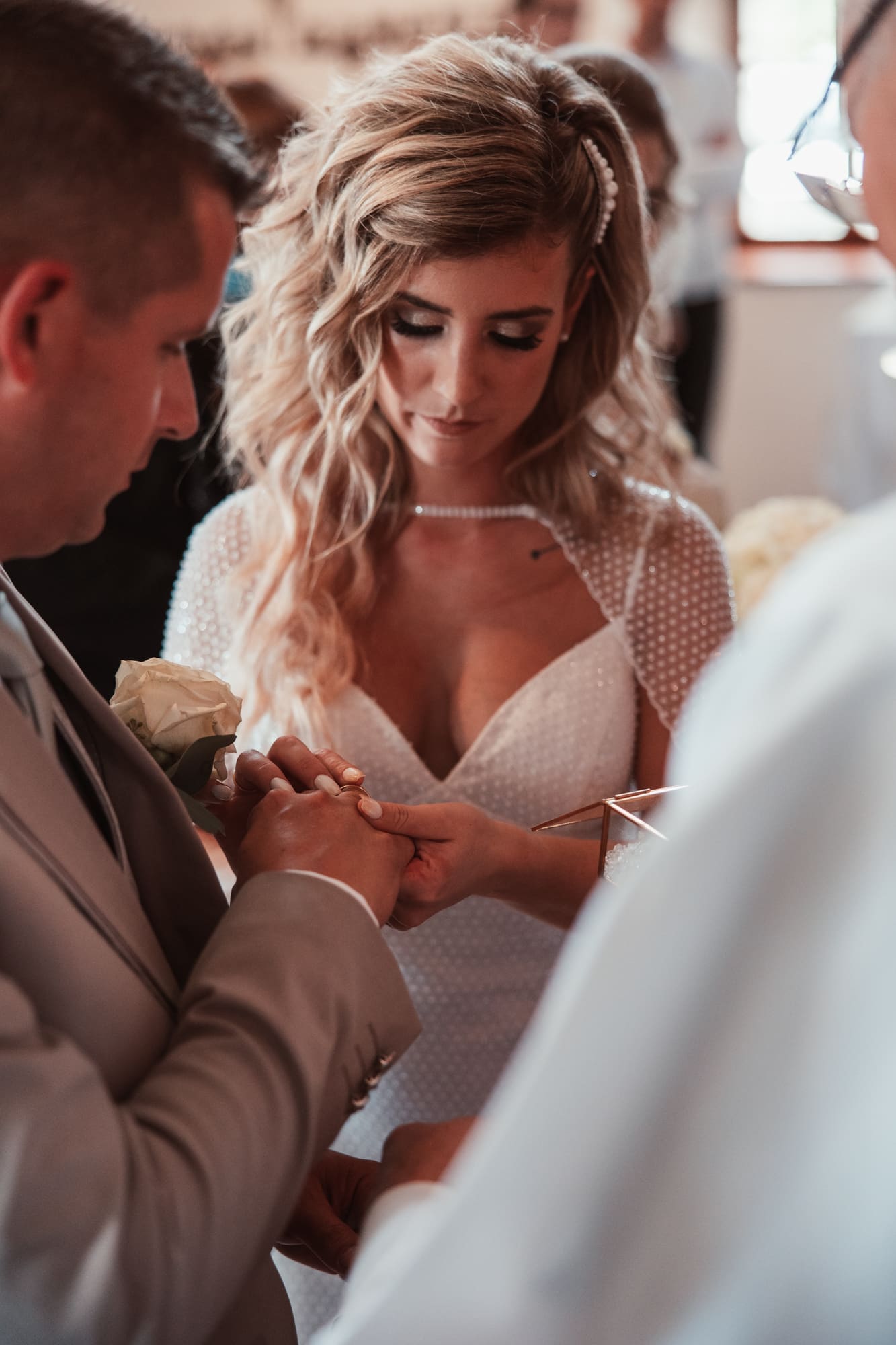 Zala and Matej exchanging wedding rings during their ceremony at the Church of St. Michael in Šmihelj, Slovenia.