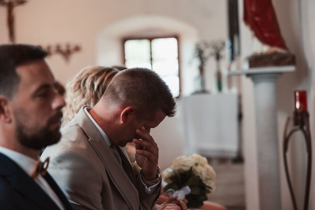 Matej becoming emotional during the wedding ceremony at the Church of St. Michael in Šmihelj.
