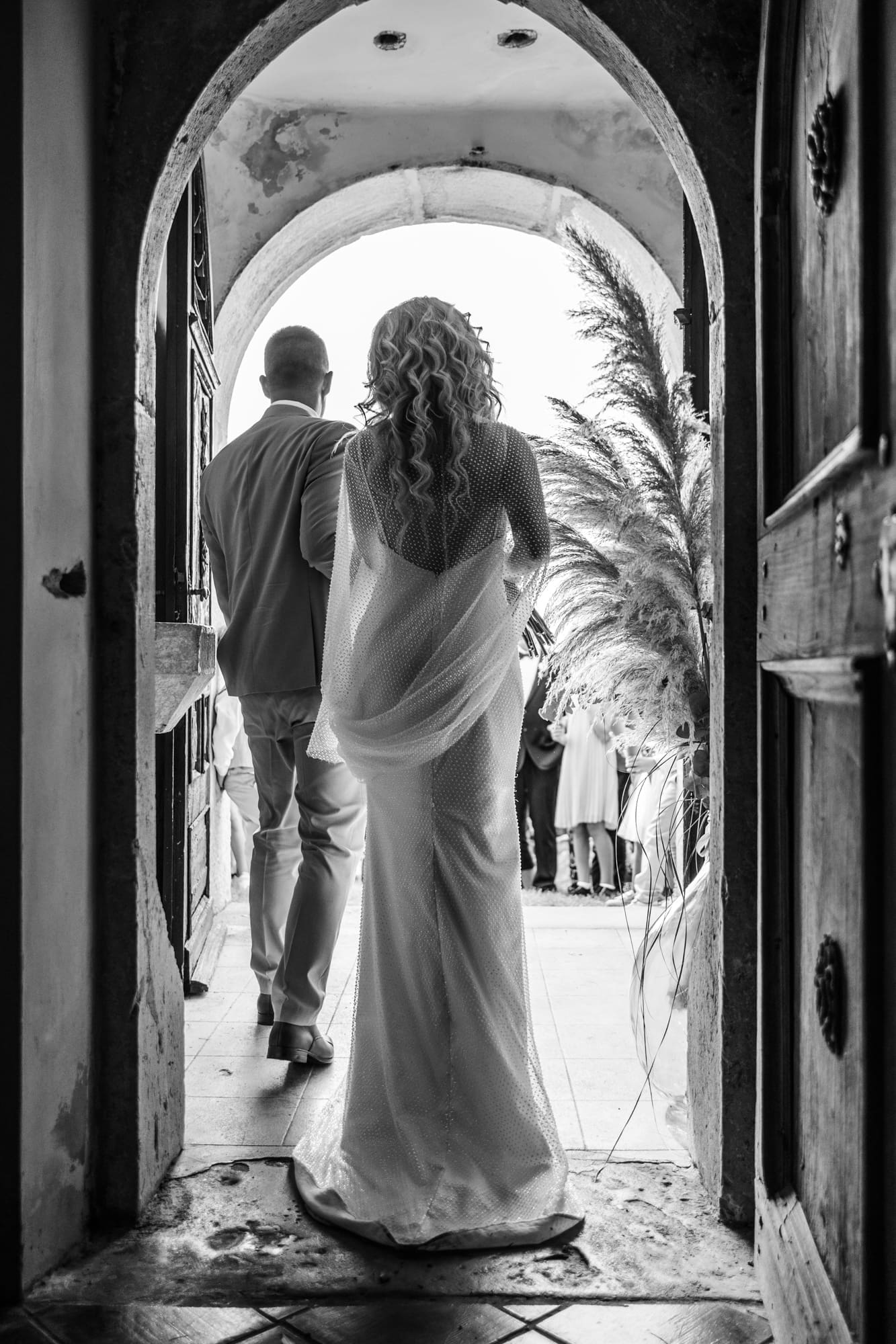 Zala and Matej walking out of the Church of St. Michael after their wedding ceremony in Šmihelj, Slovenia.