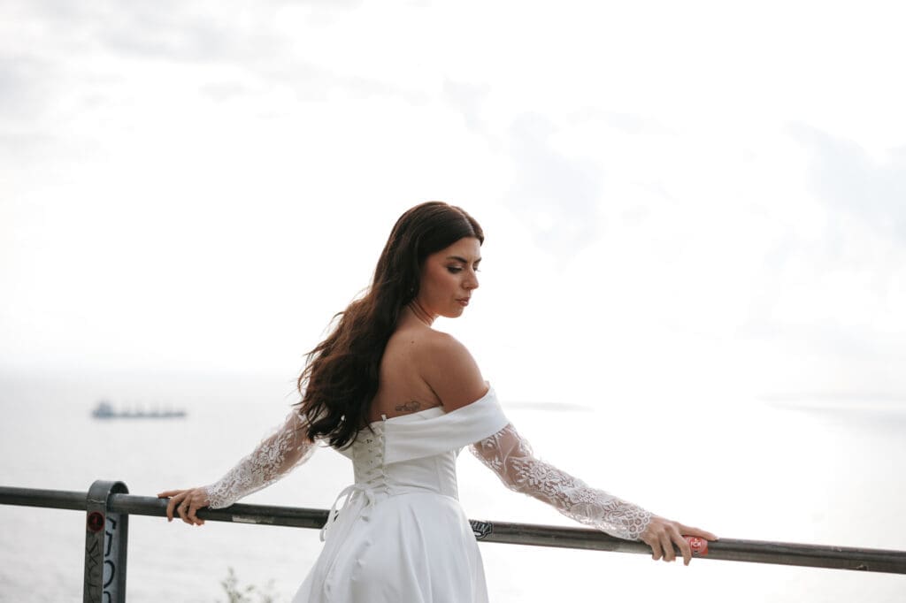 Bride overlooking the Adriatic Sea at a scenic wedding photography location near Trieste, Italy