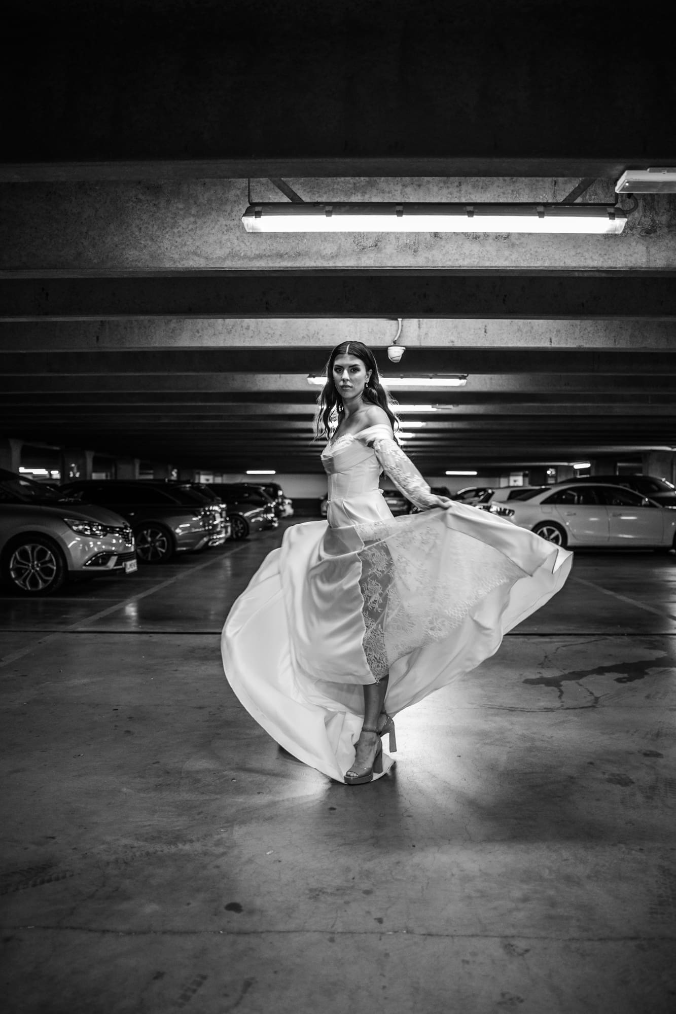 Bride twirling in the Silos parking garage during a black and white editorial wedding photoshoot in Trieste, Italy