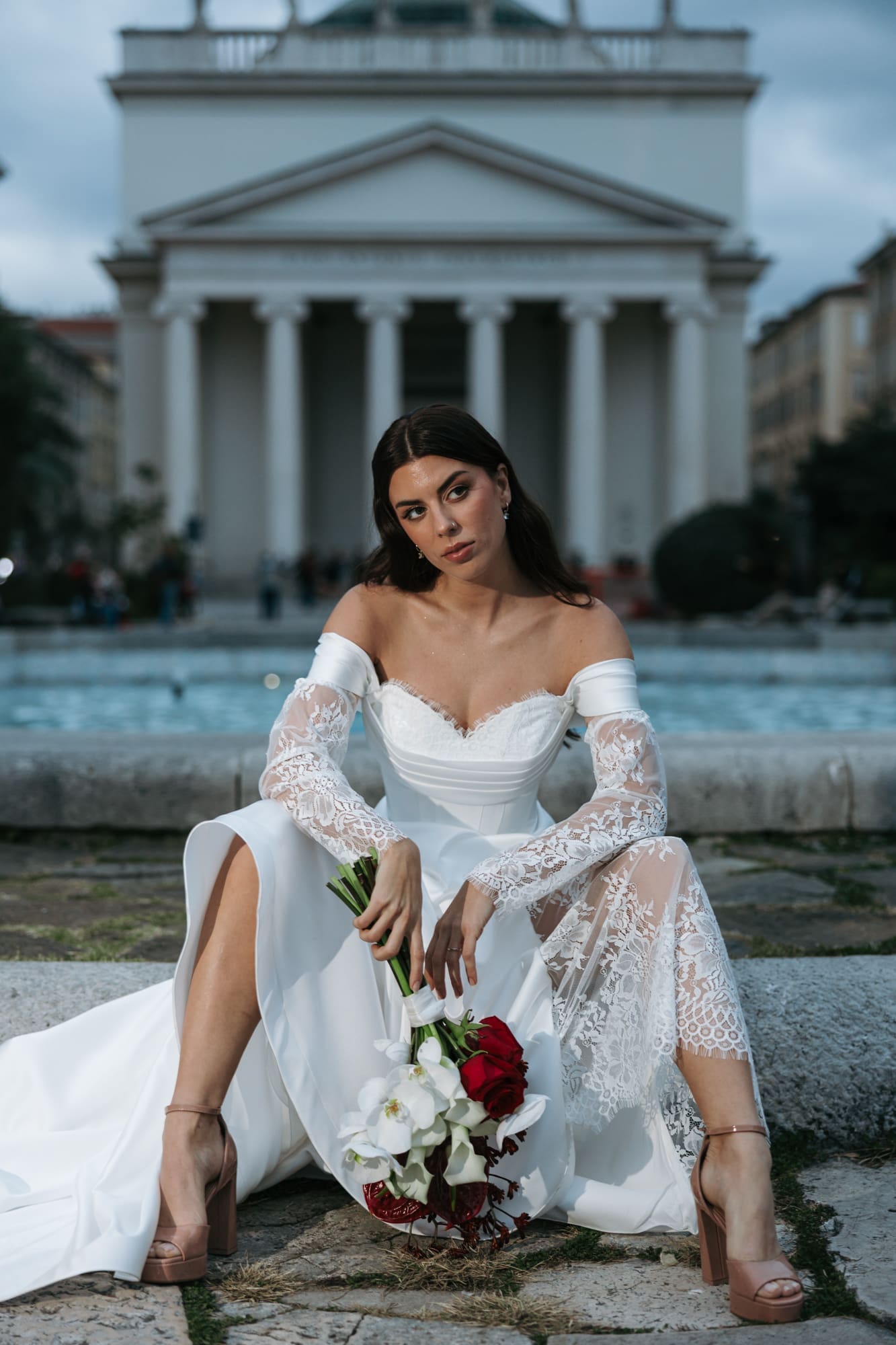 Bride holding a wedding bouquet in front of Sant’Antonio Nuovo during a romantic wedding photoshoot in the historic center of Trieste, Italy