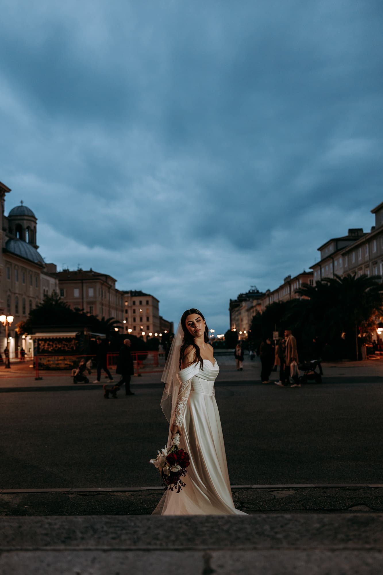 Bride posing in Piazza Sant’Antonio near Sant’Antonio Nuovo during an evening wedding photoshoot in Trieste, Italy