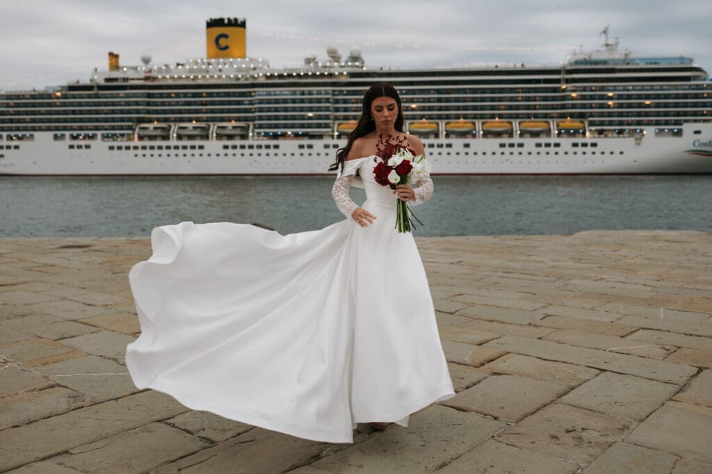 Bride on Molo Audace with Trieste harbor and cruise ship in the background