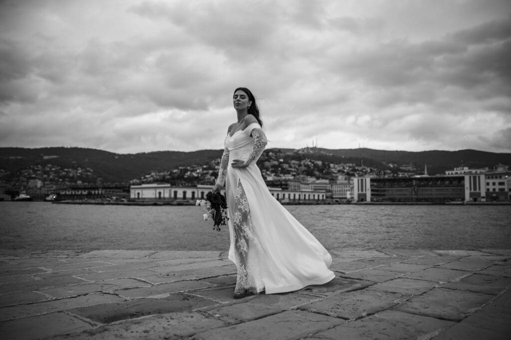 Bride walking on Molo Audace waterfront in Trieste, Italy