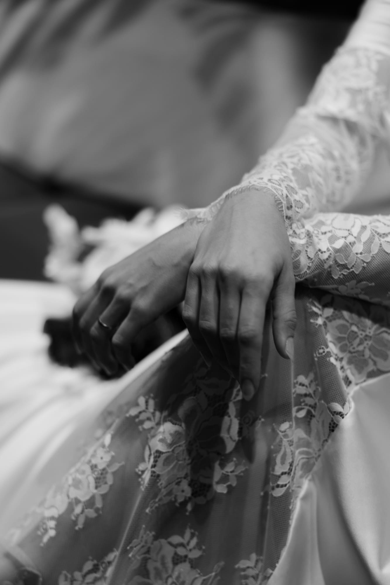 Close-up of bridal hands resting on a lace wedding dress at The Modernist Hotel during an editorial wedding photoshoot in Trieste, Italy