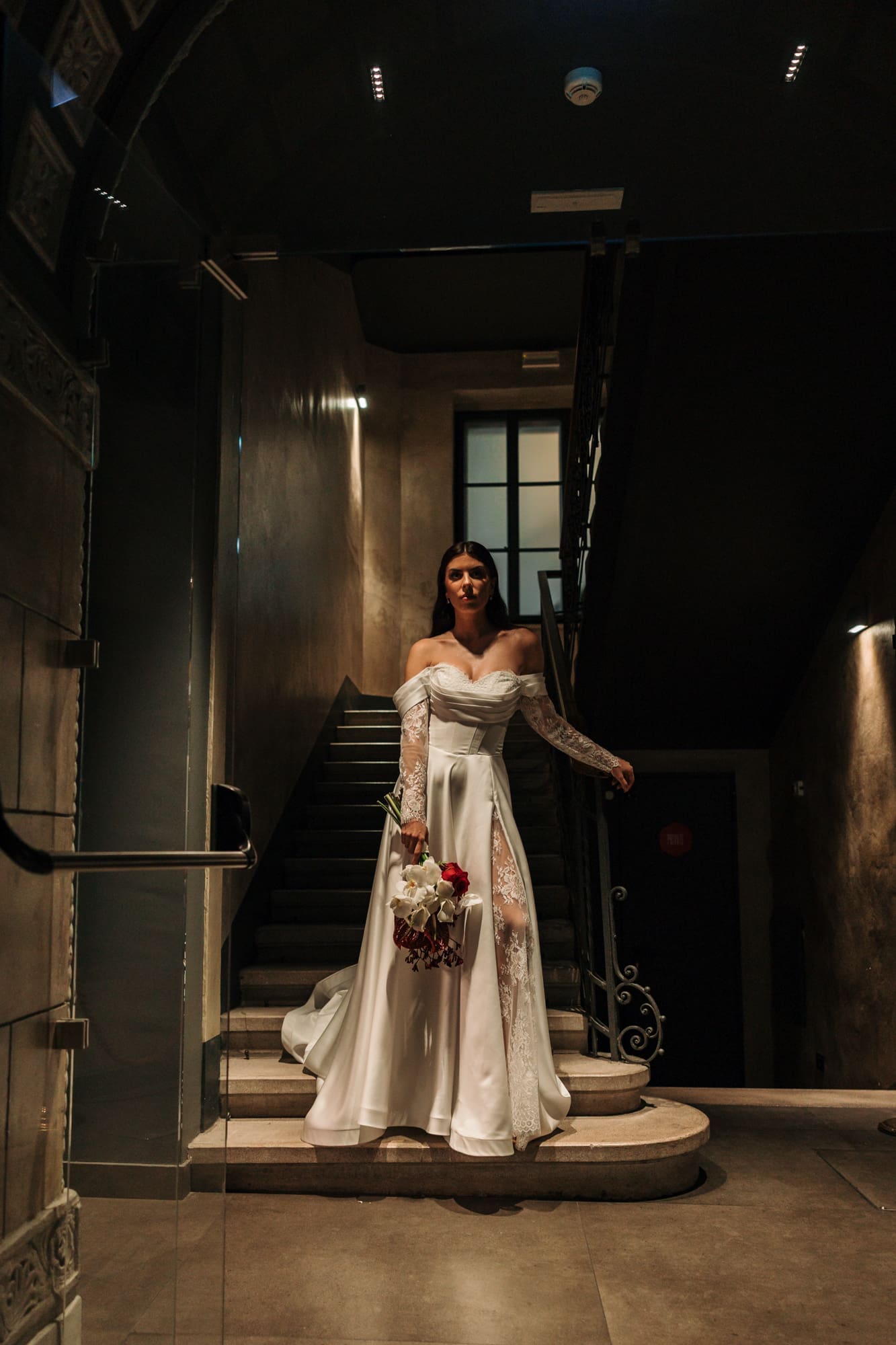 Bride standing on the staircase at The Modernist Hotel on Corso Italia during an editorial wedding photoshoot in Trieste, Italy