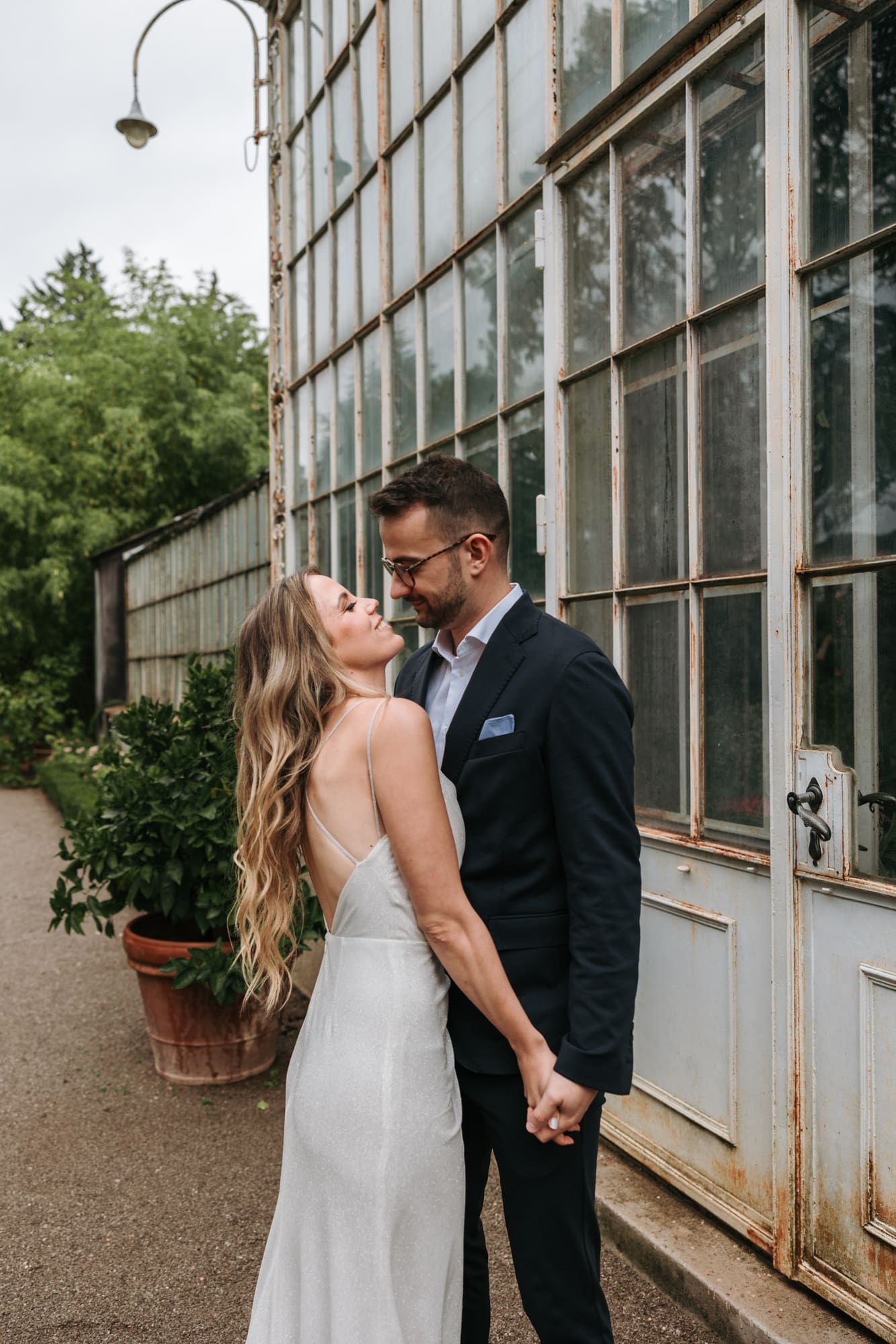 Wedding portraits beside the historic greenhouse at Villa Mirasasso wedding venue in Slovenia.