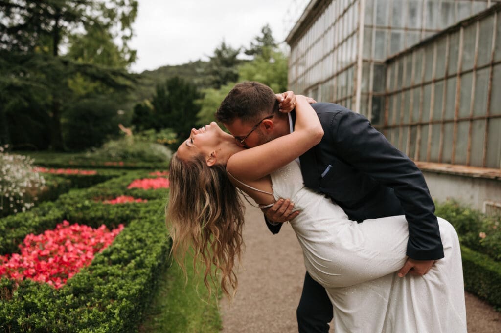 Bride and groom kissing in the gardens of Villa Mirasasso, one of Slovenia's most unique wedding venues.