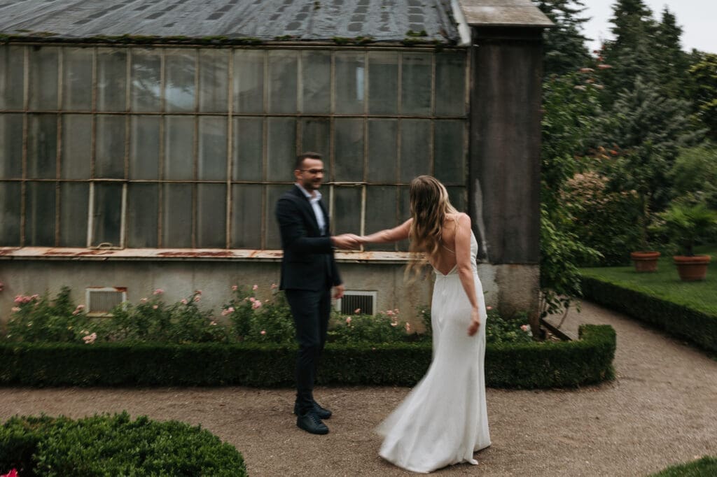 Newlyweds sharing a quiet moment in the gardens of Villa Mirasasso wedding venue in Slovenia.